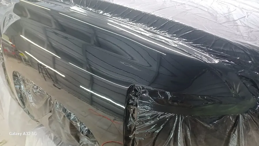 Black car masked for paint prep
